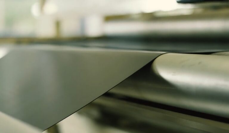 Black rubber compound sheet on a processing line | 生产线上的黑色橡胶混炼胶片